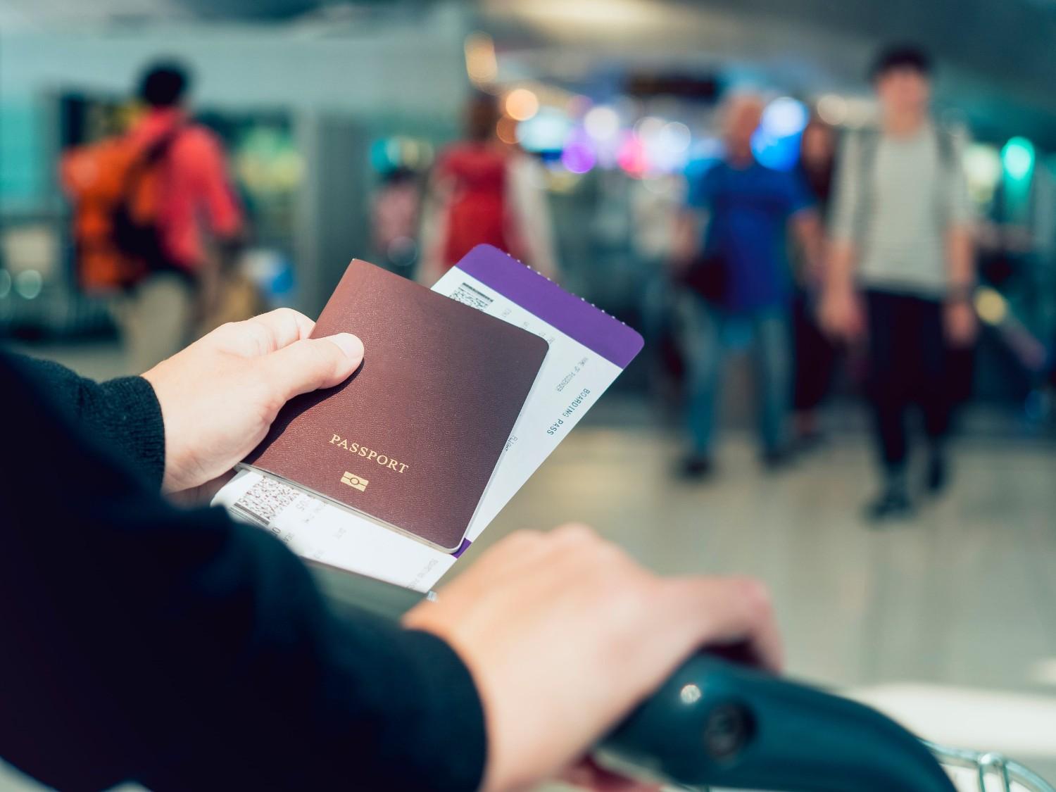 Hand Holding Passport Boarding Pass Ticket