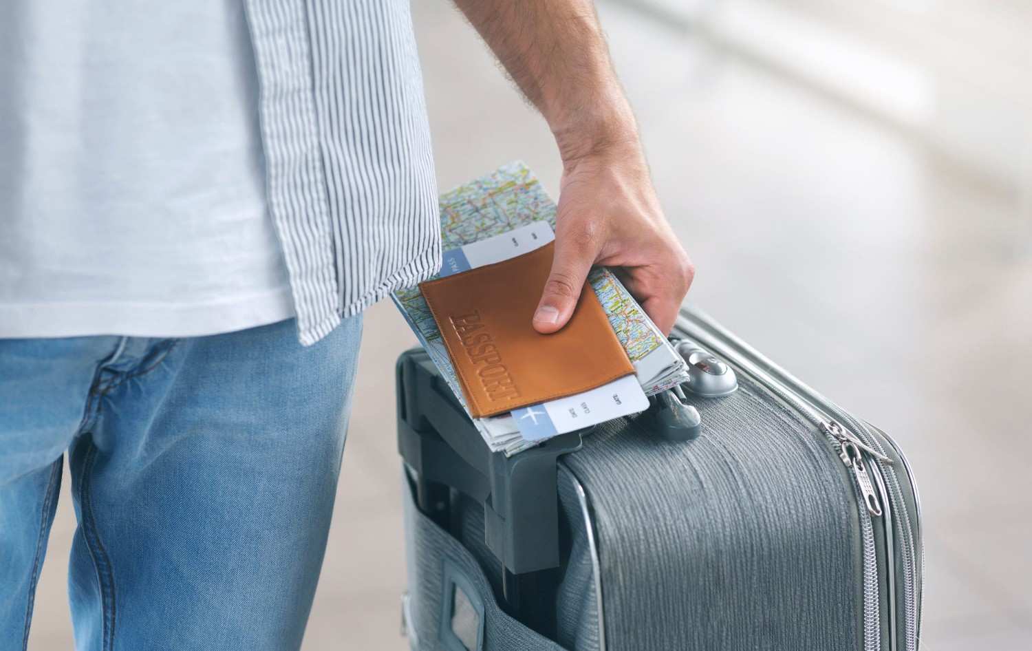 Man Holding His Passport And Carrying Suitcase