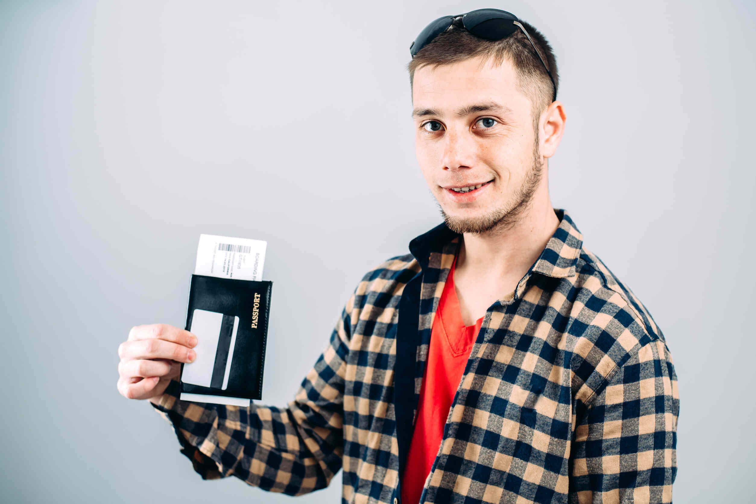 Man In Shirt With Plane Tickets And Passport