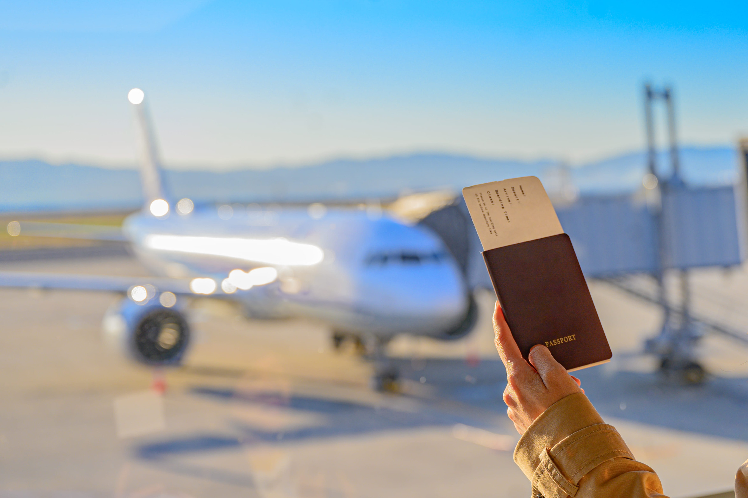 Passport And Boarding Pass In Hand Of Passenger
