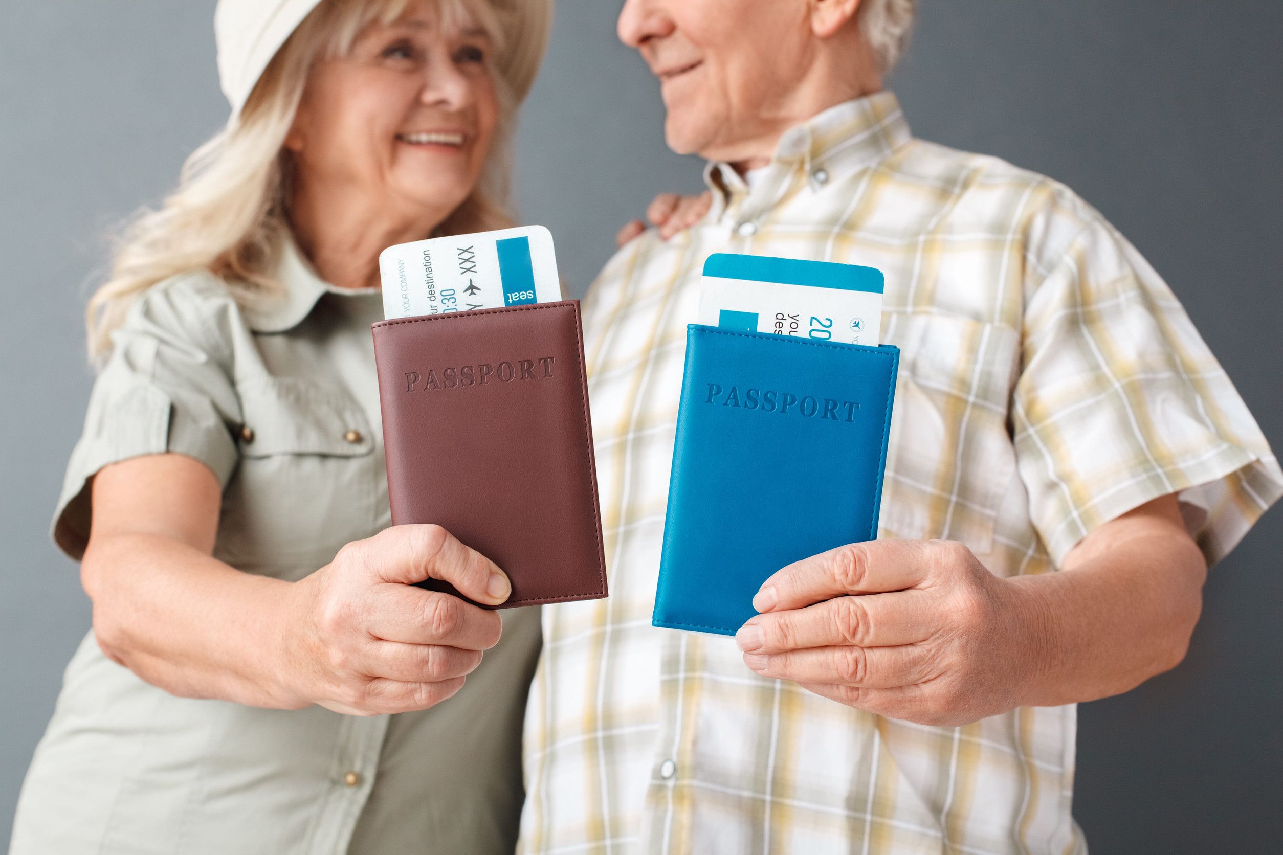 Senior Tourists Holding Passports And Tickets