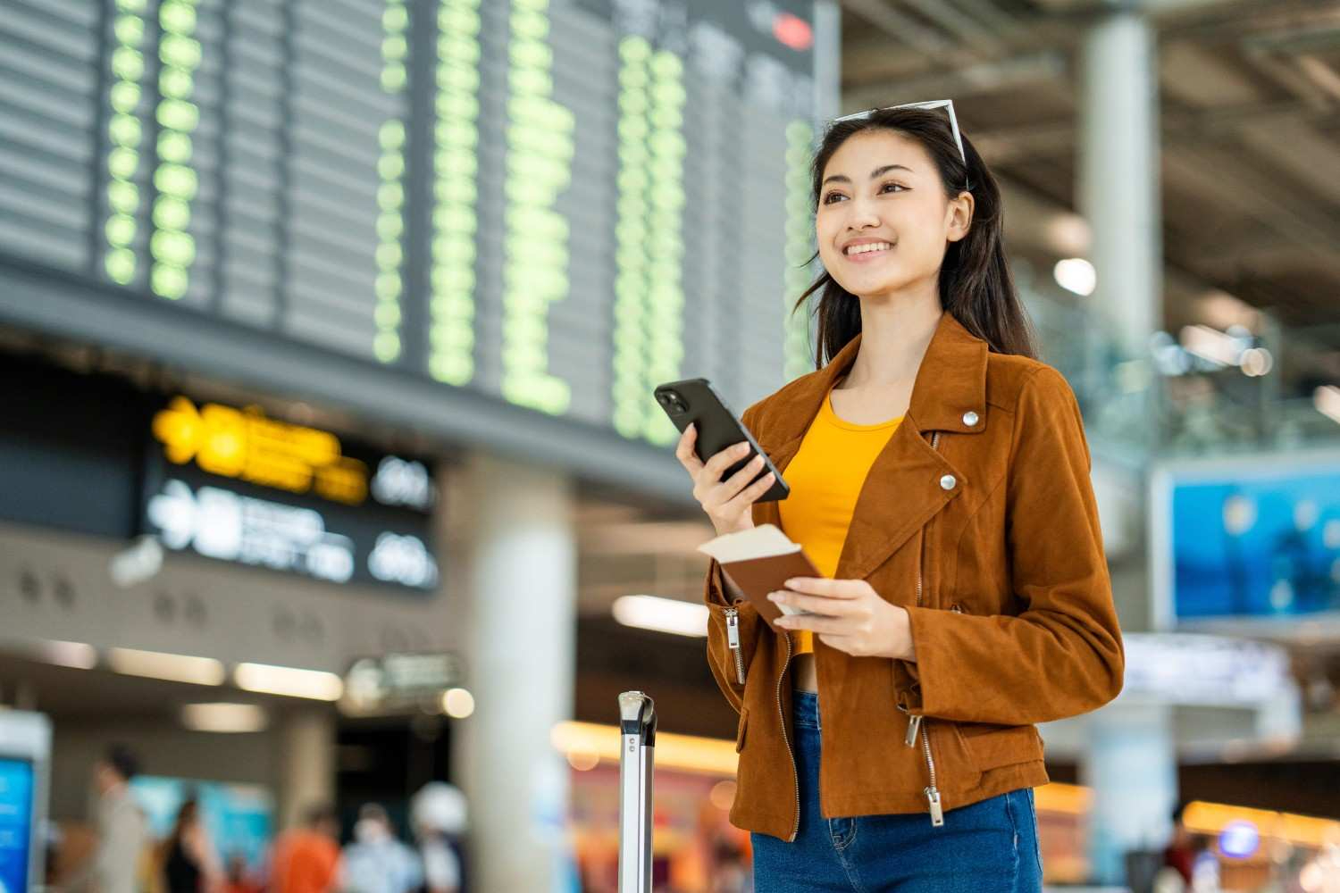 Smiling Woman Traveler With Passport Boarding Pass At Airport
