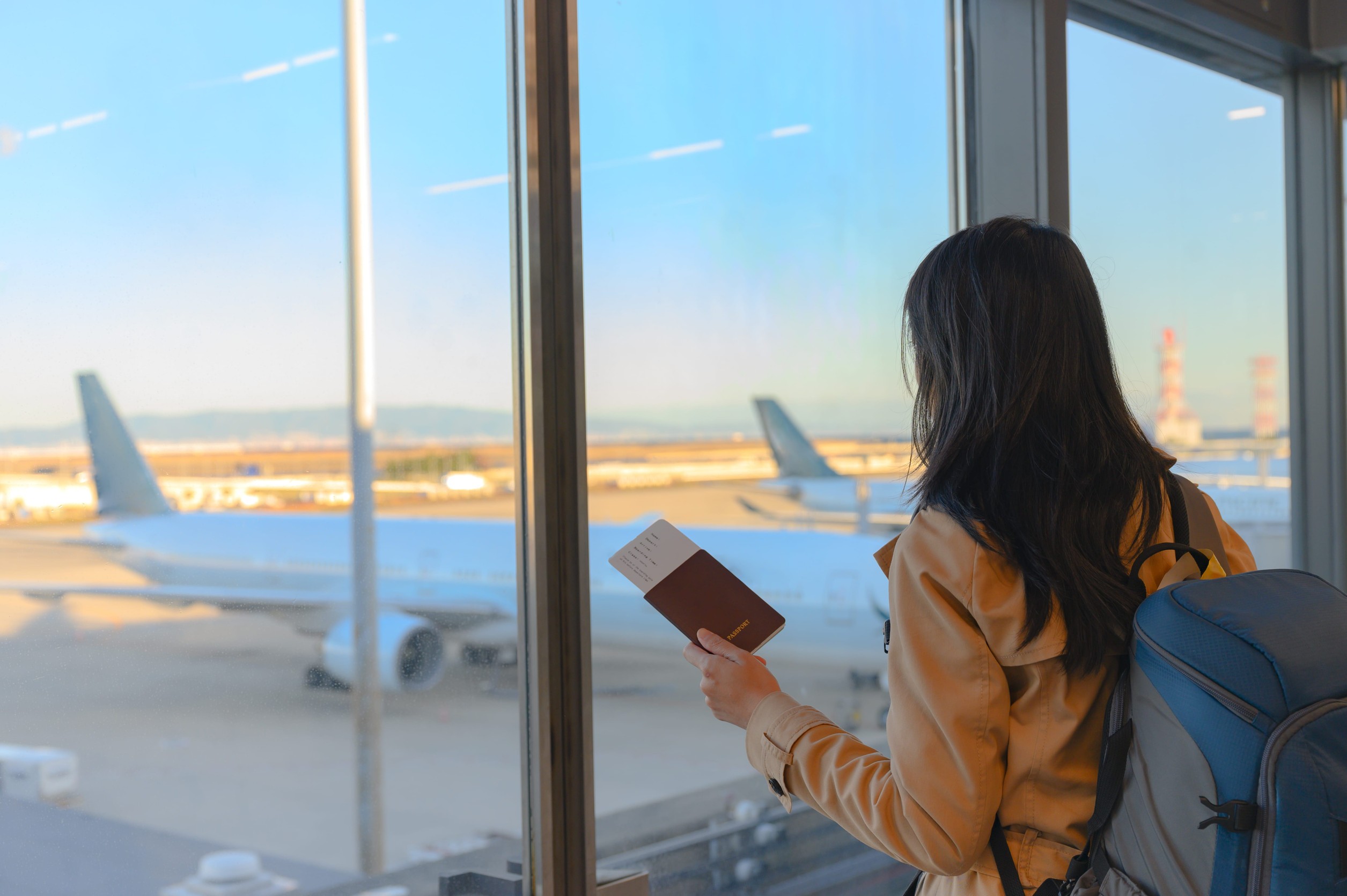 Tourist Holding Passport And Boarding Pass