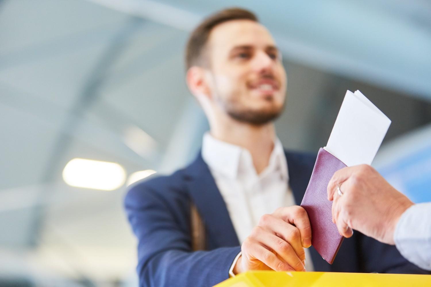 Traveler Shows His Passport At The Check In Desk