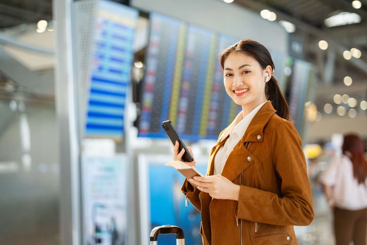 Woman Holding Passport With Ticket Boarding Pass And Smartphone
